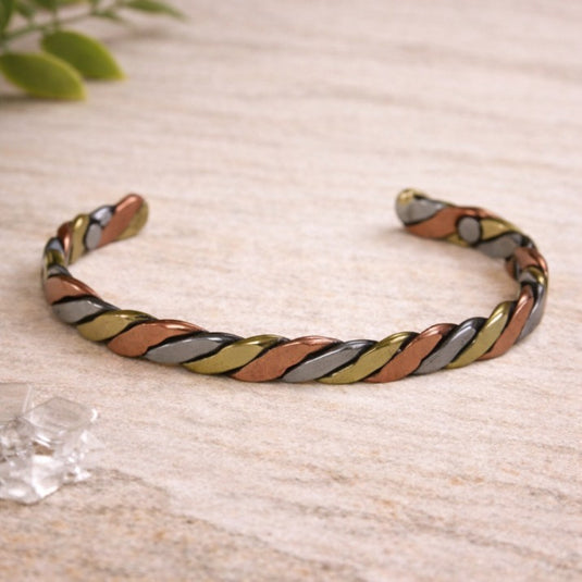 Colorful braided bracelet on a light wooden surface