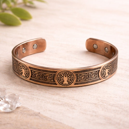 Copper bracelet with intricate designs on a light background